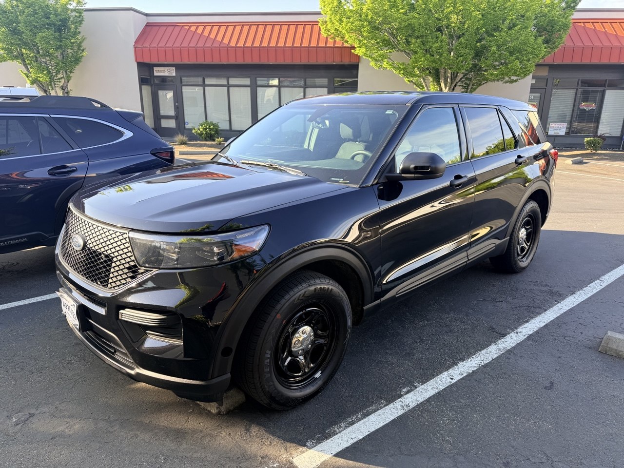 Black Falcon patrol SUV parked outside a commercial building
