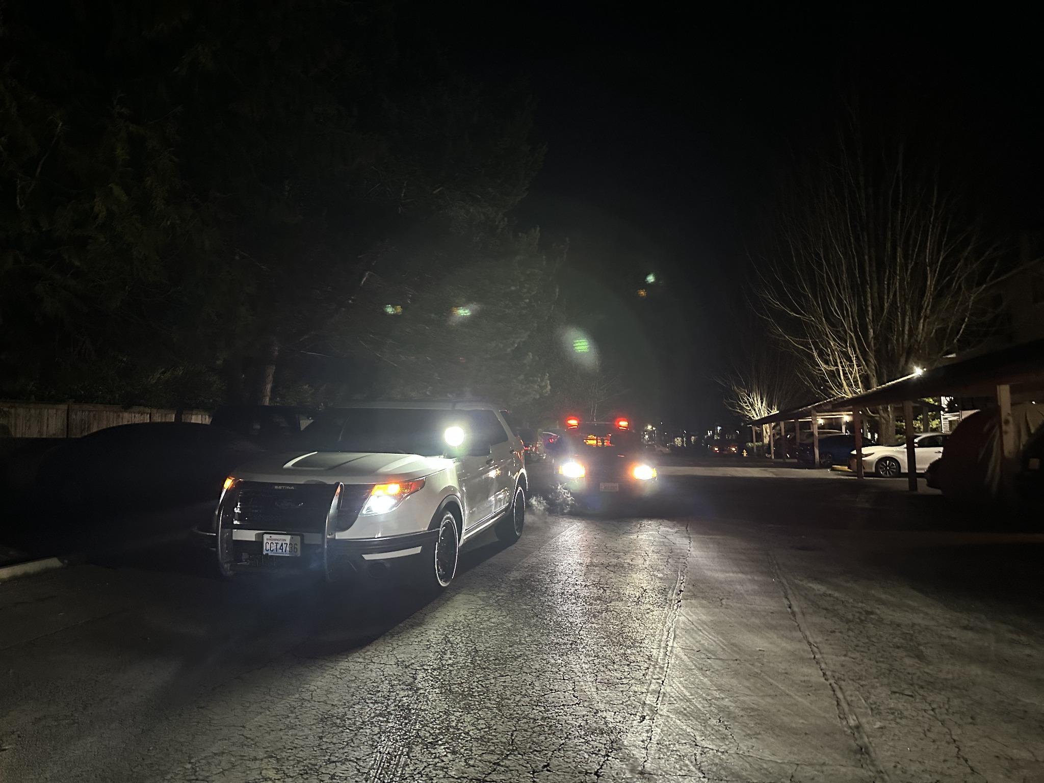 White Falcon patrol SUV with a darker patrol vehicle behind it at night