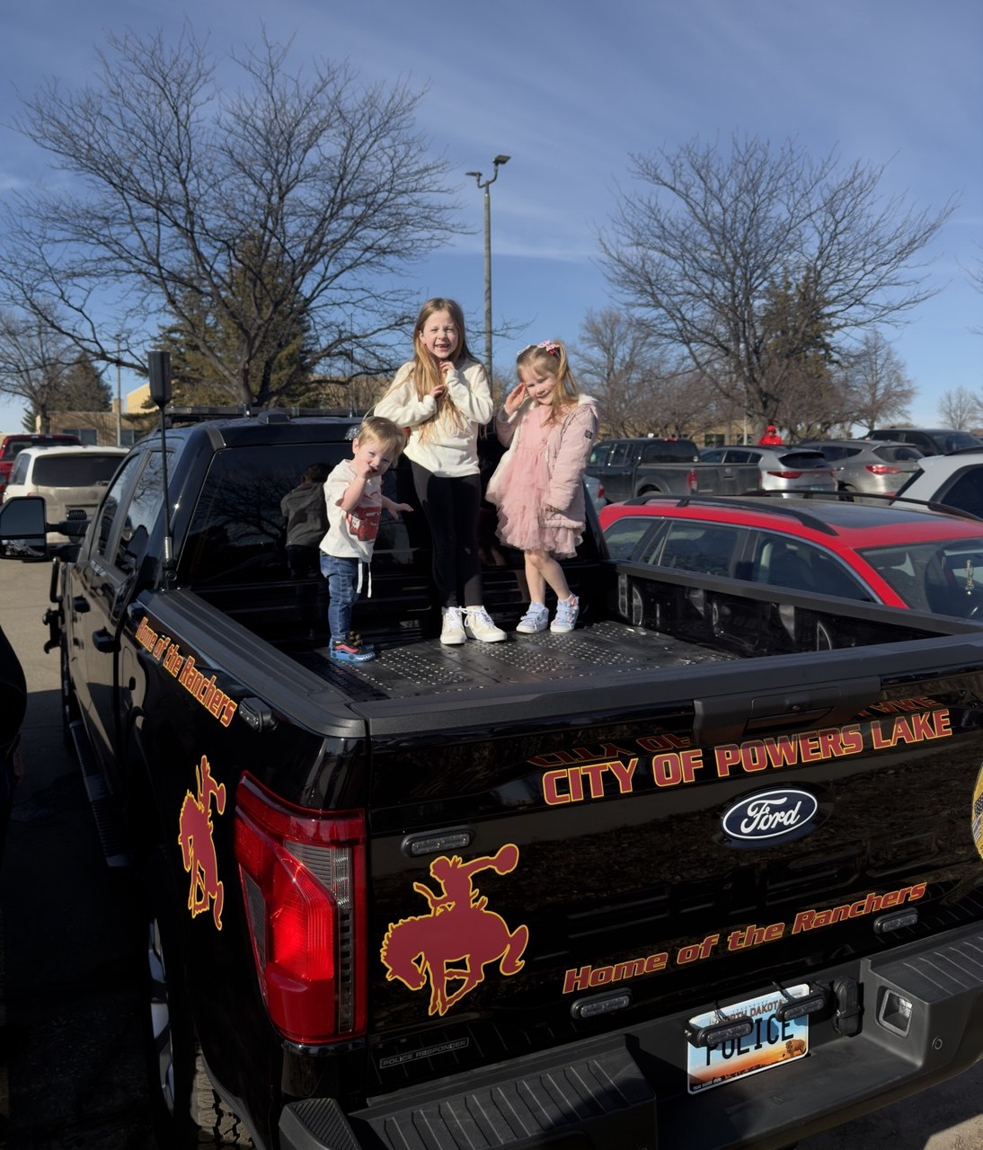 Family with the City of Powers Lake police truck